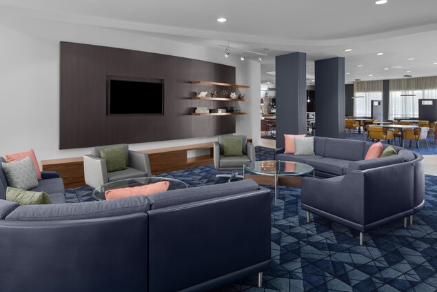 Lobby with couches and chairs and TV