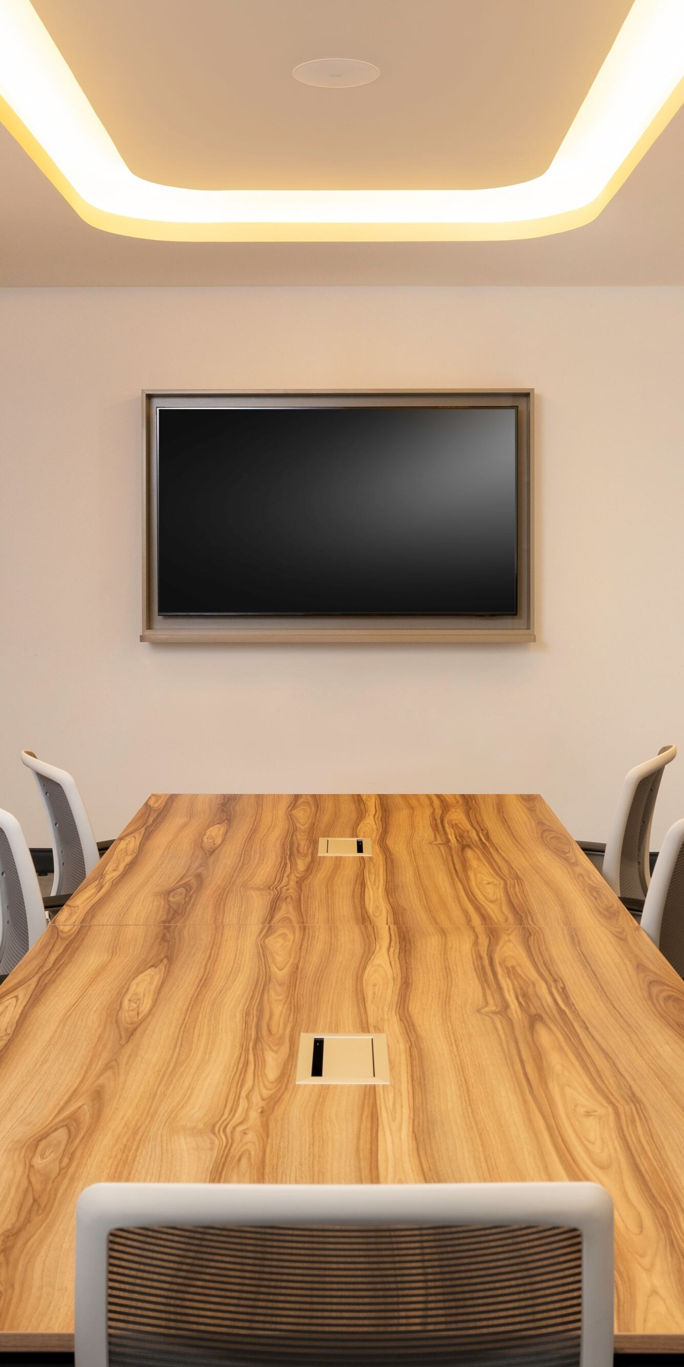Meeting room with wood table and screen