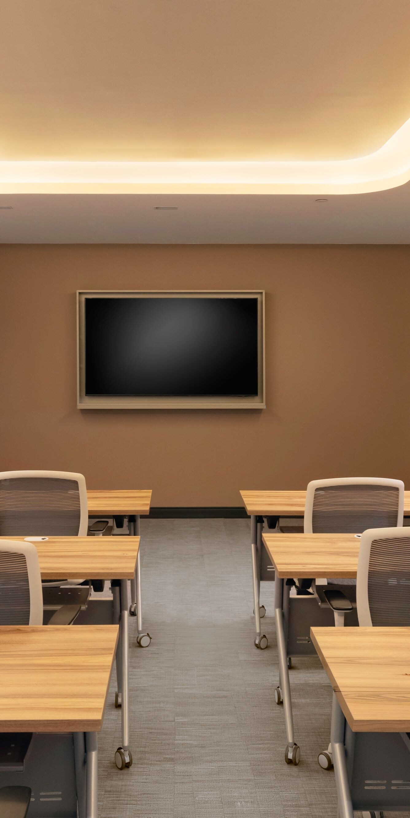 Meeting room with classroom setup and screen