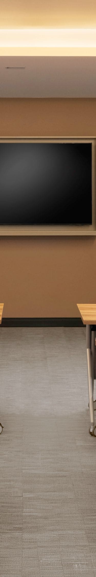 Meeting room with classroom setup and screen