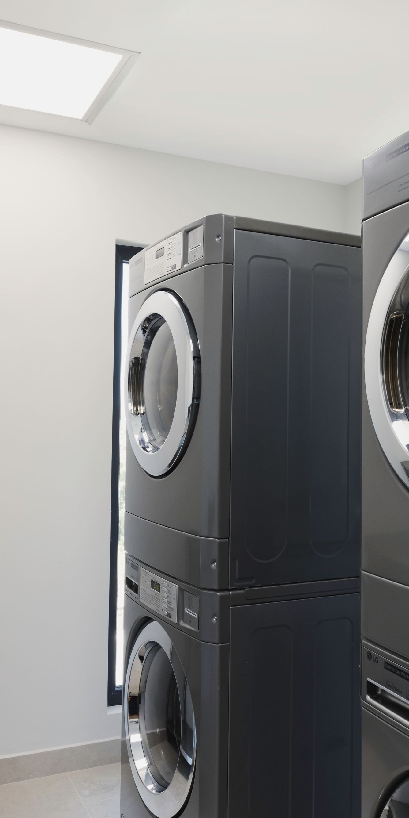 Laundry room with stacked washer and dryer