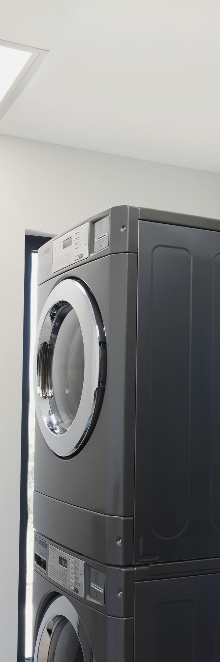 Laundry room with stacked washer and dryer