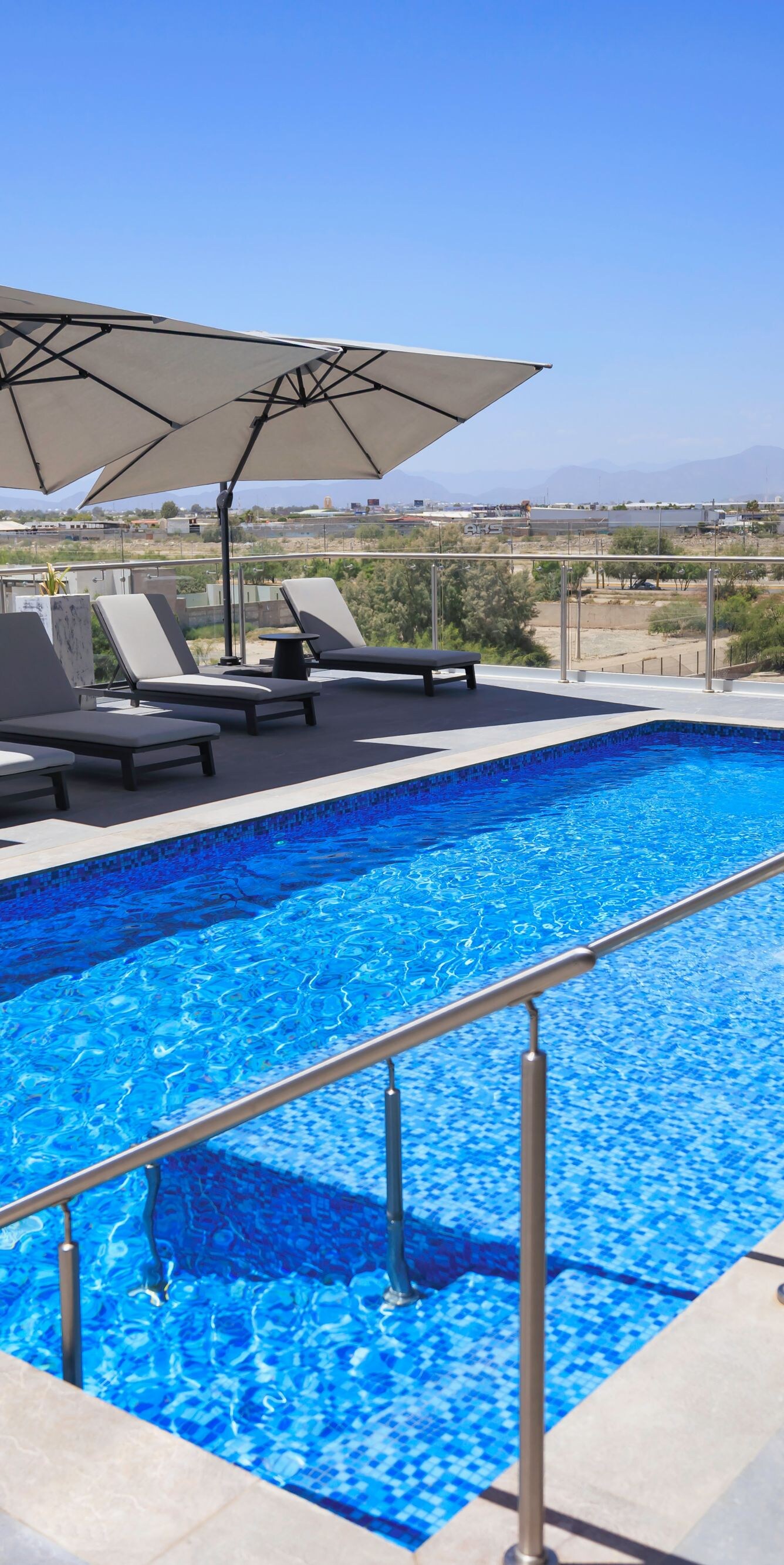 Rooftop pool with lounge chairs and views