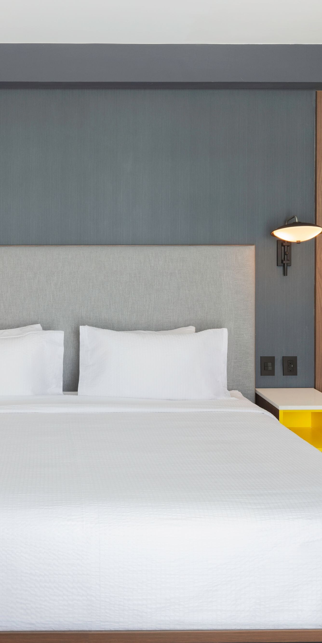 King guest room with yellow nightstands