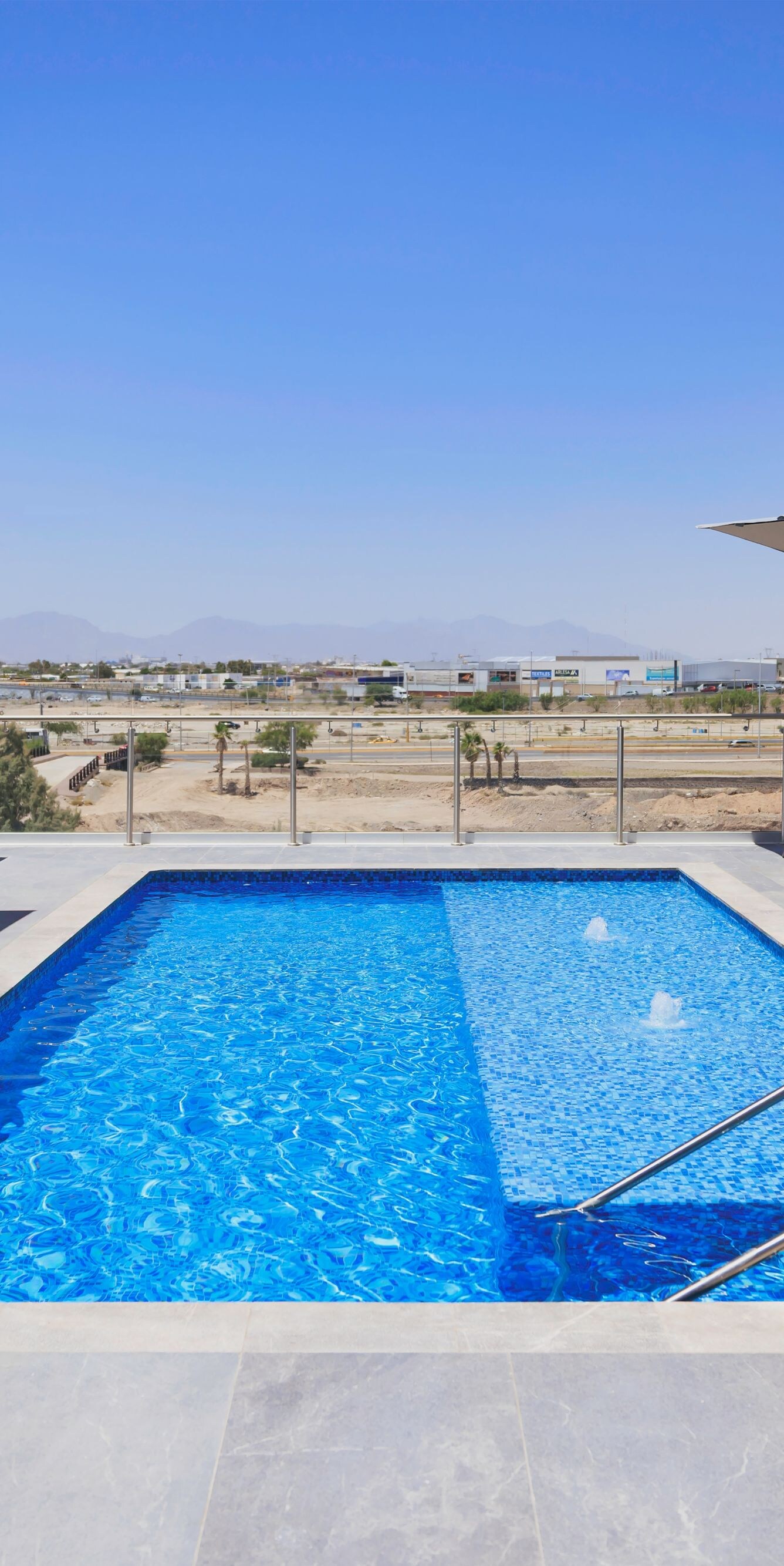 Rooftop pool with lounge chairs and views