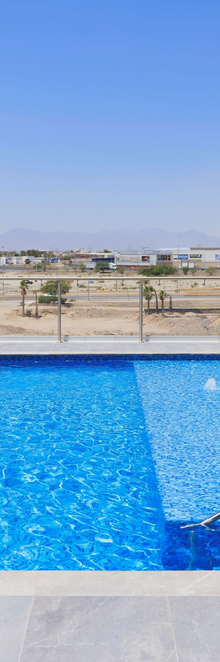 Rooftop pool with lounge chairs and views