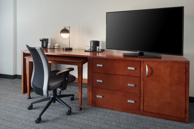 Desk space with TV and coffee amenities on top
