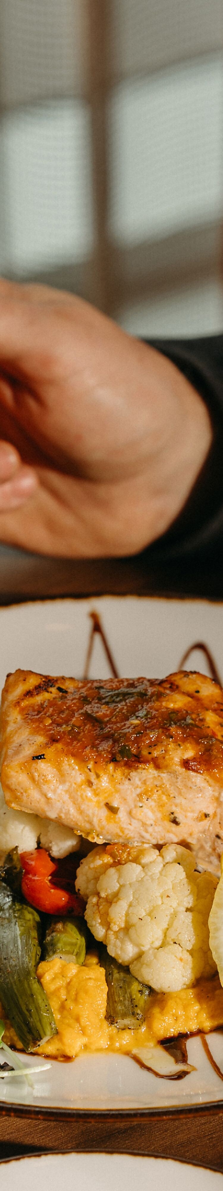 Grilled salmon entrée on a restaurant table.