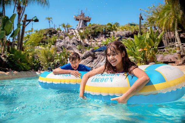 Two kids with inner tubes at Disney Lagoon.