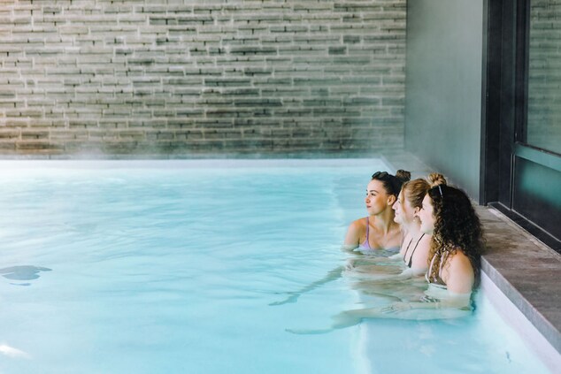 Women sitting a pool