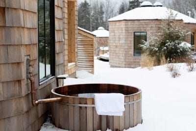 snowy exterior with hot tub and towel