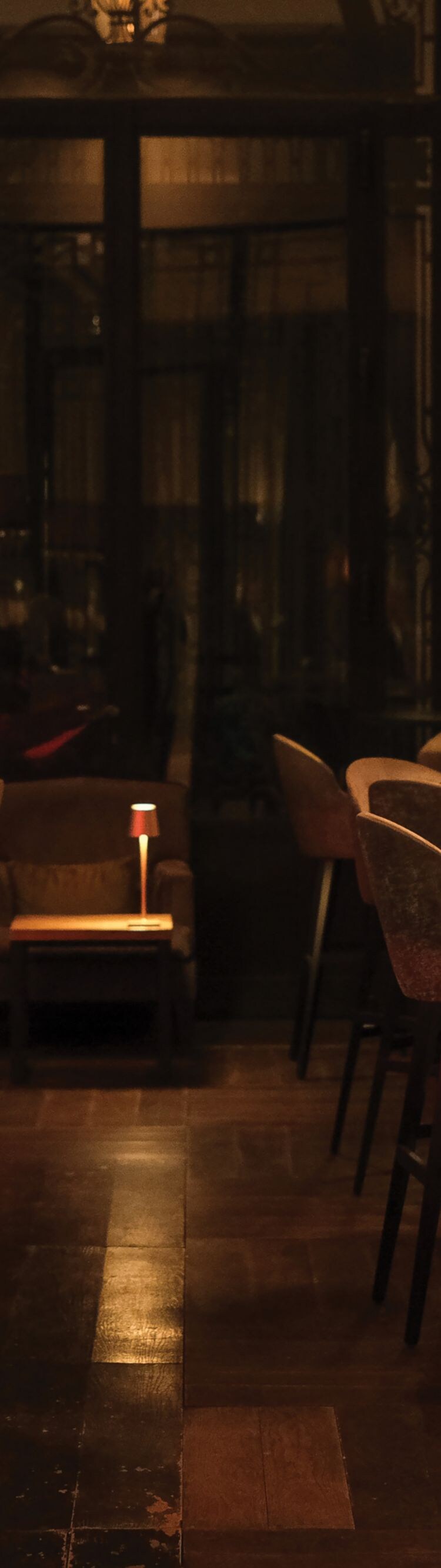 Dimmed bar with velvet chairs.
