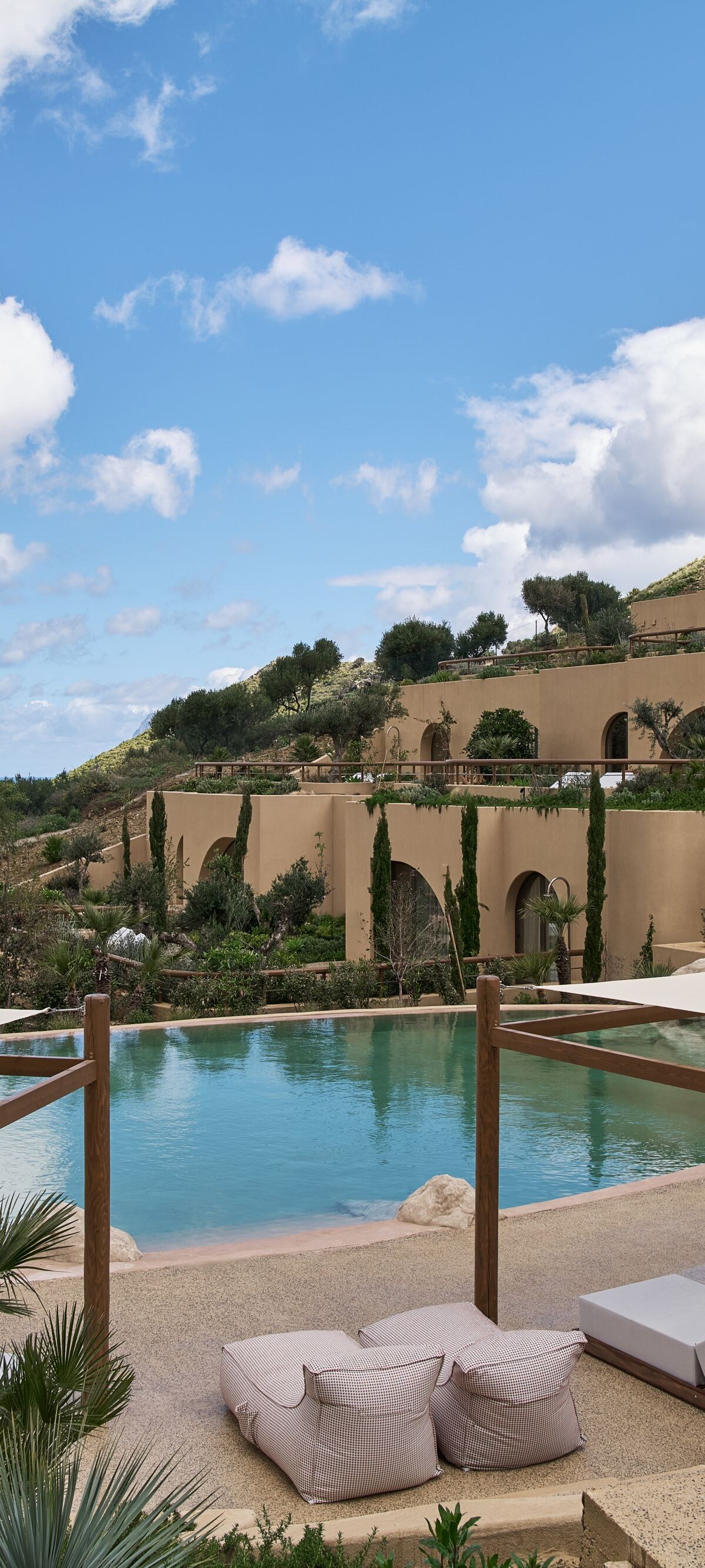 Terraced resort pool with cabanas and ocean