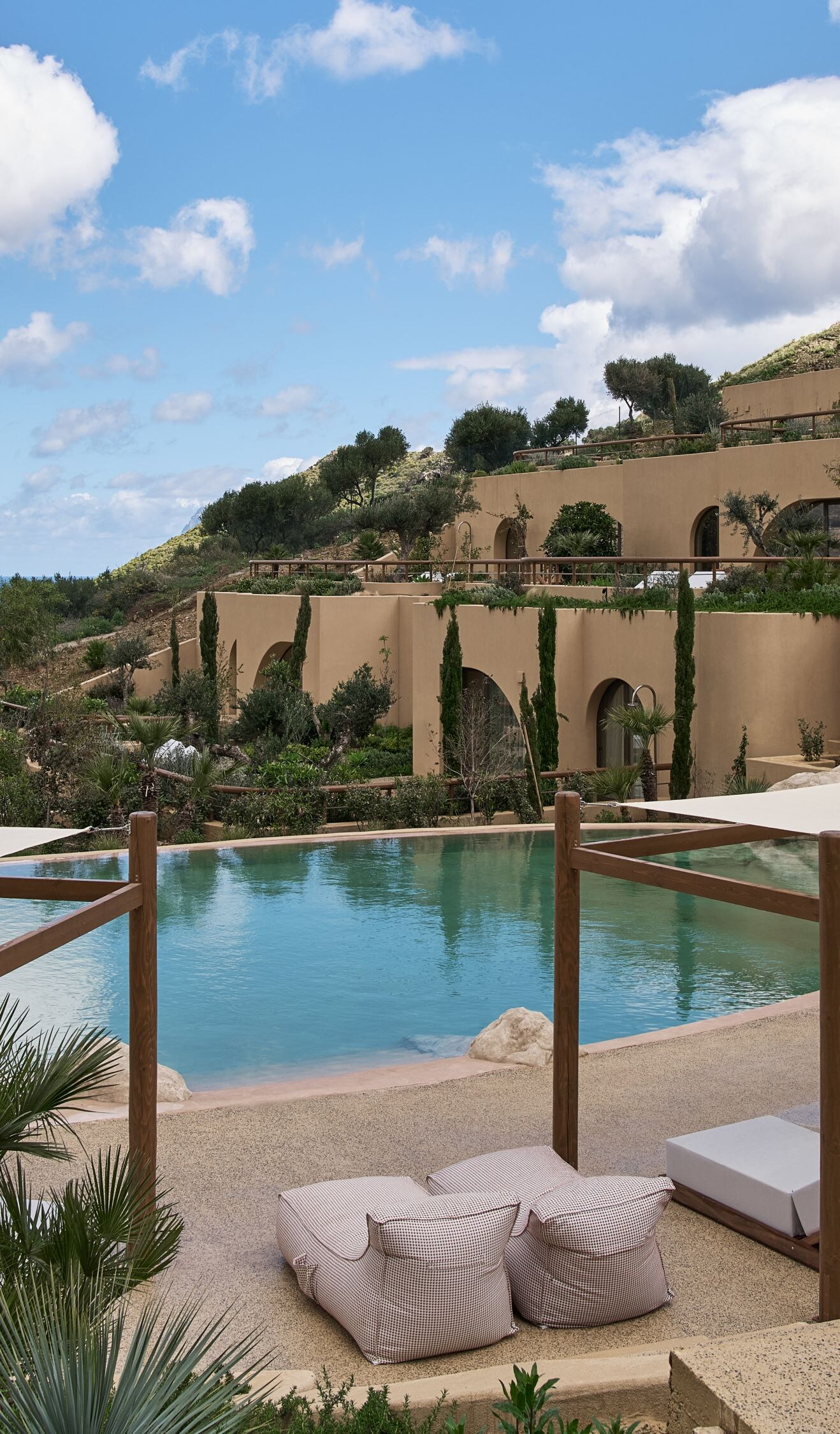 Terraced resort pool with cabanas and ocean