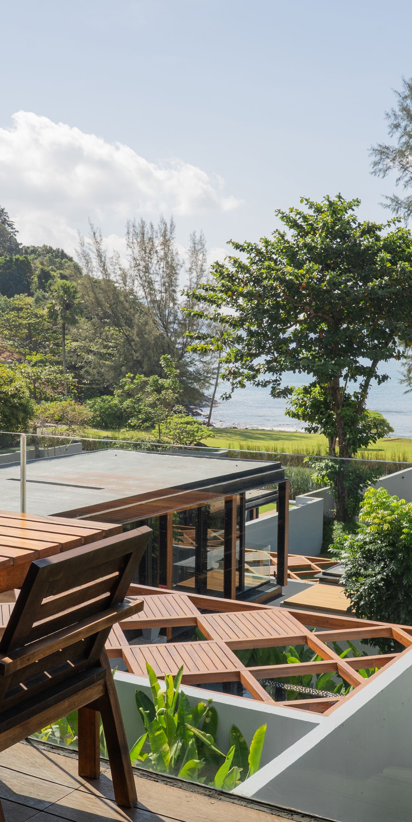 Wooden patio table overlooking trees and ocean