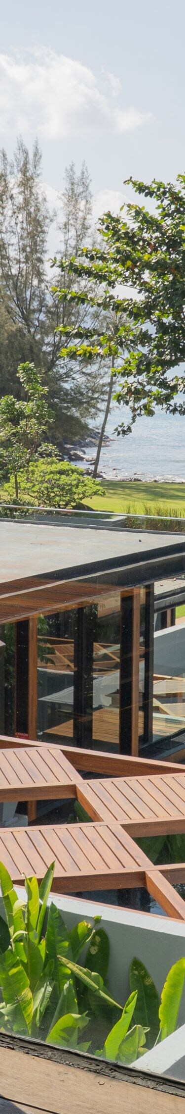 Wooden patio table overlooking trees and ocean