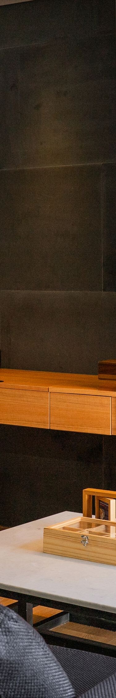 Living room with sofa, desk, and wall-mounted TV