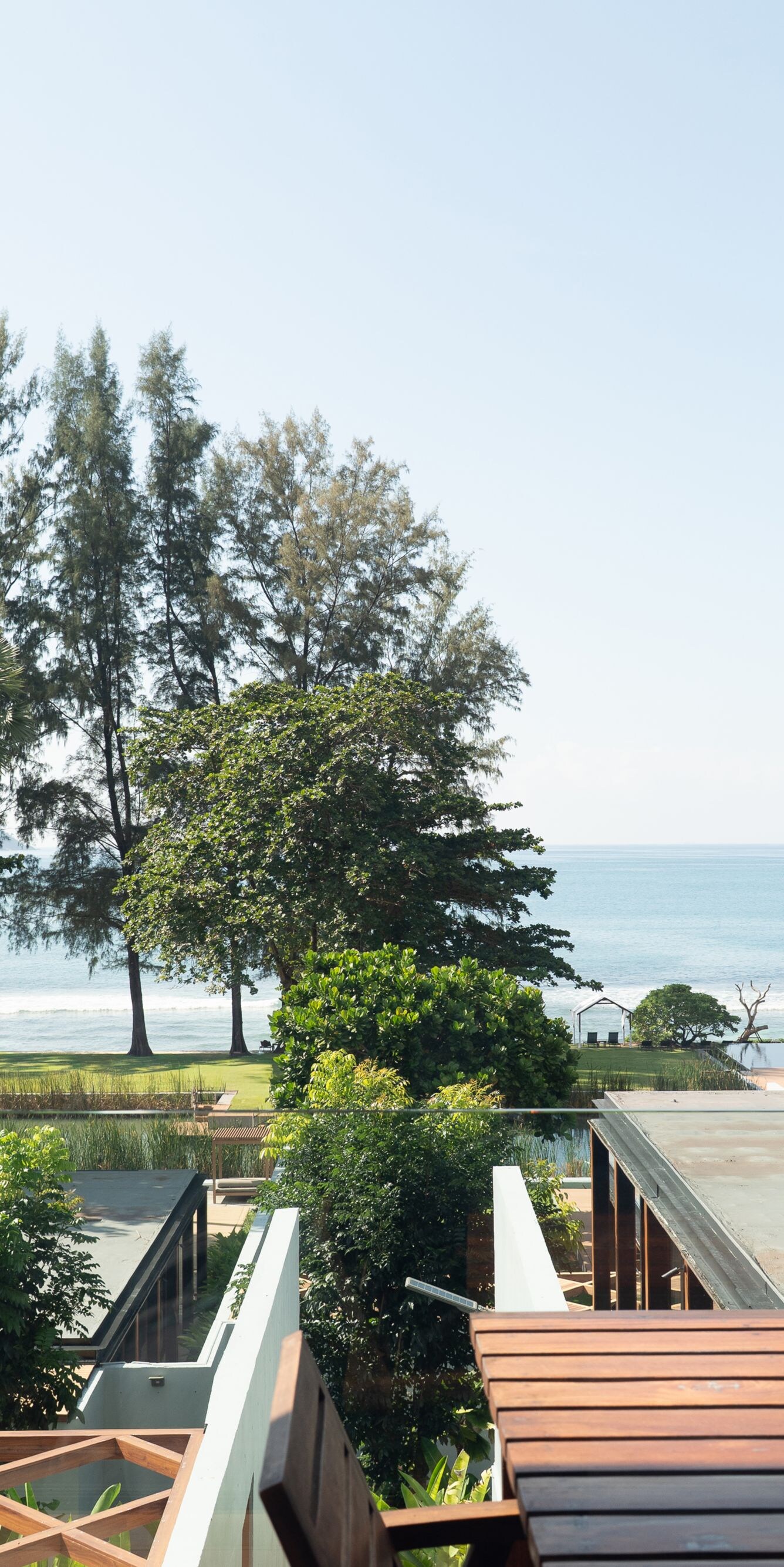 Ocean view with trees and modern rooftops