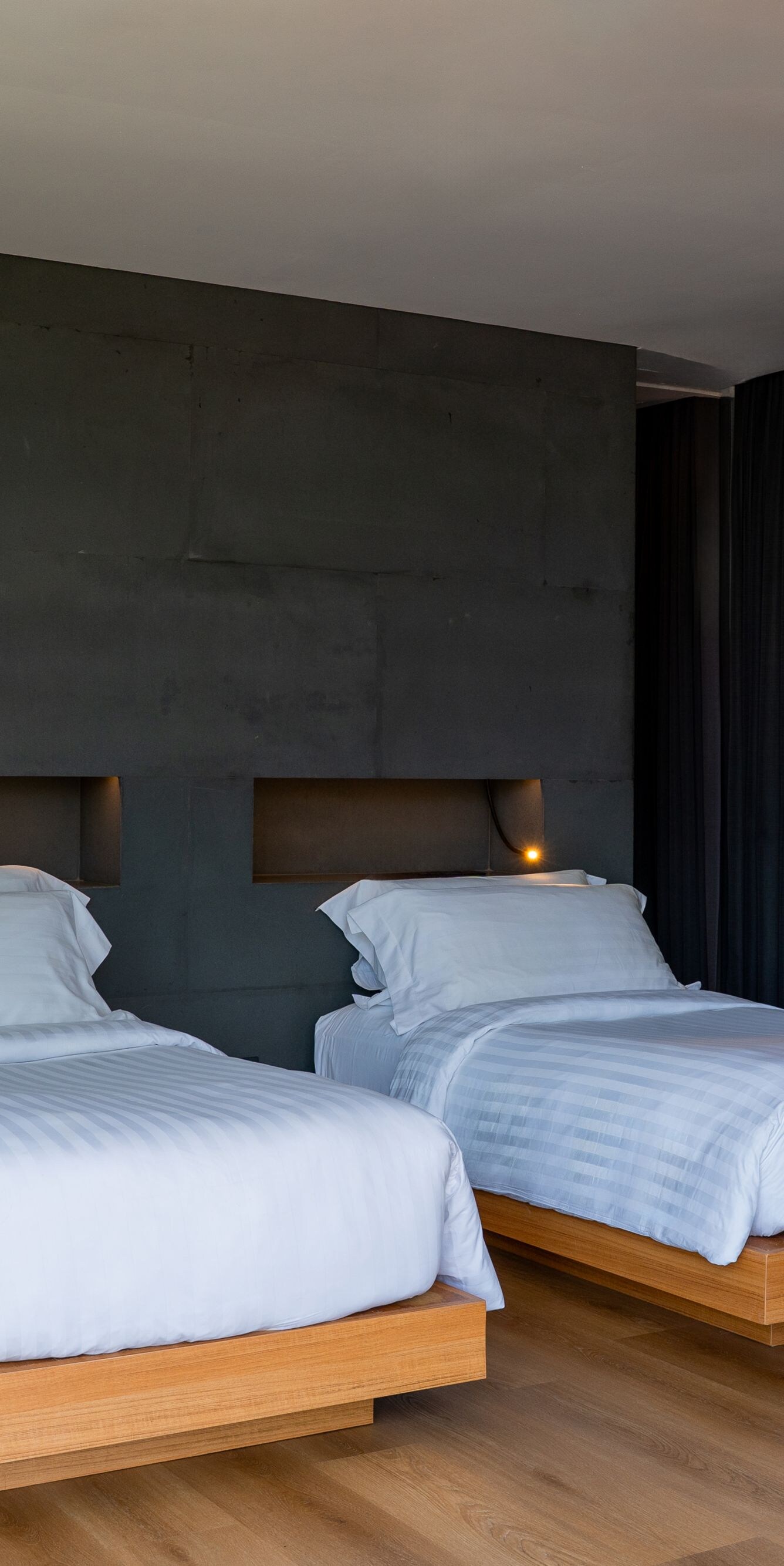 Bedroom with two twin beds and dark accent wall