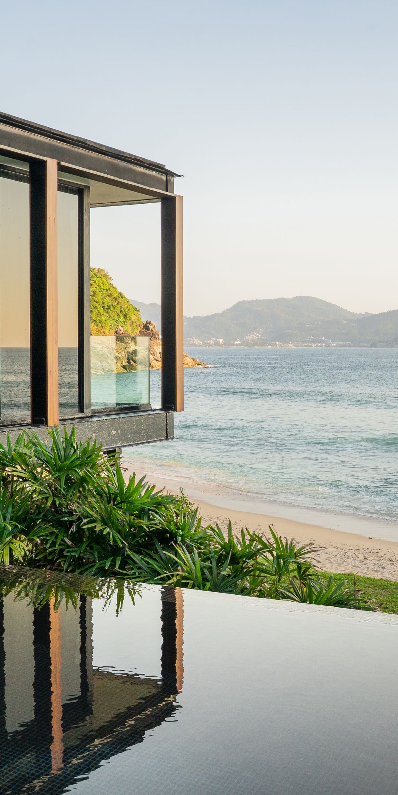 Beachfront villa with glass walls and ocean view