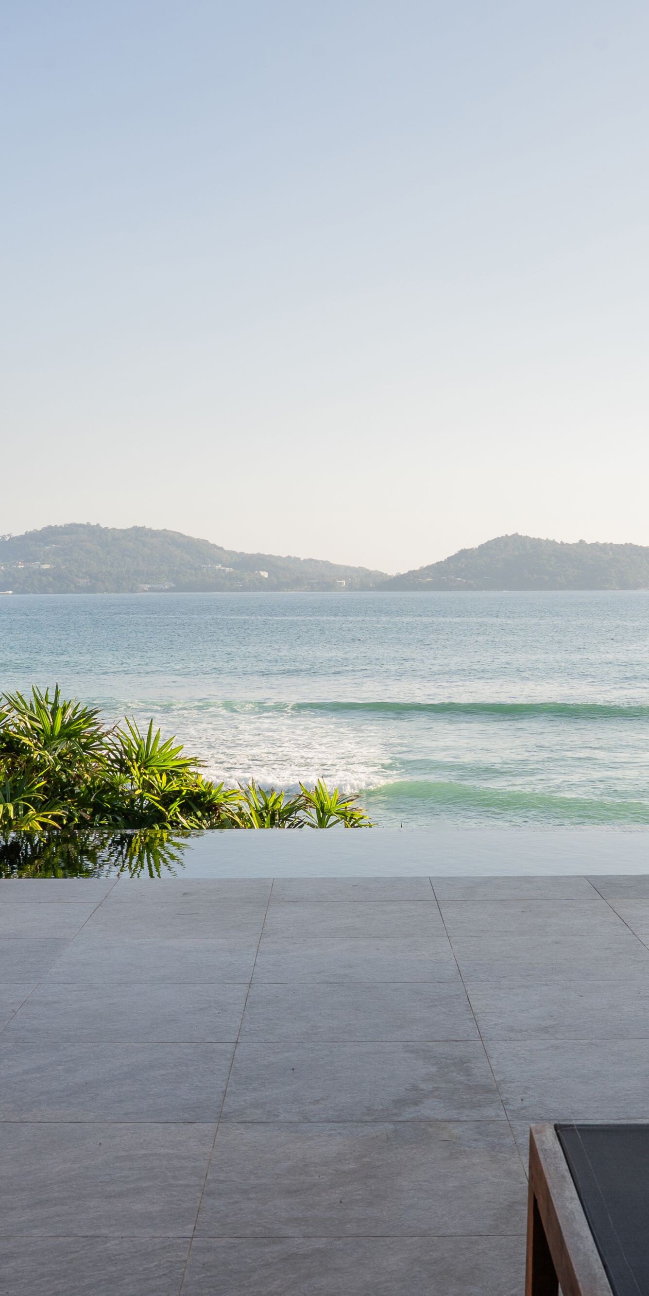 Ocean view framed by modern villa and gray wall