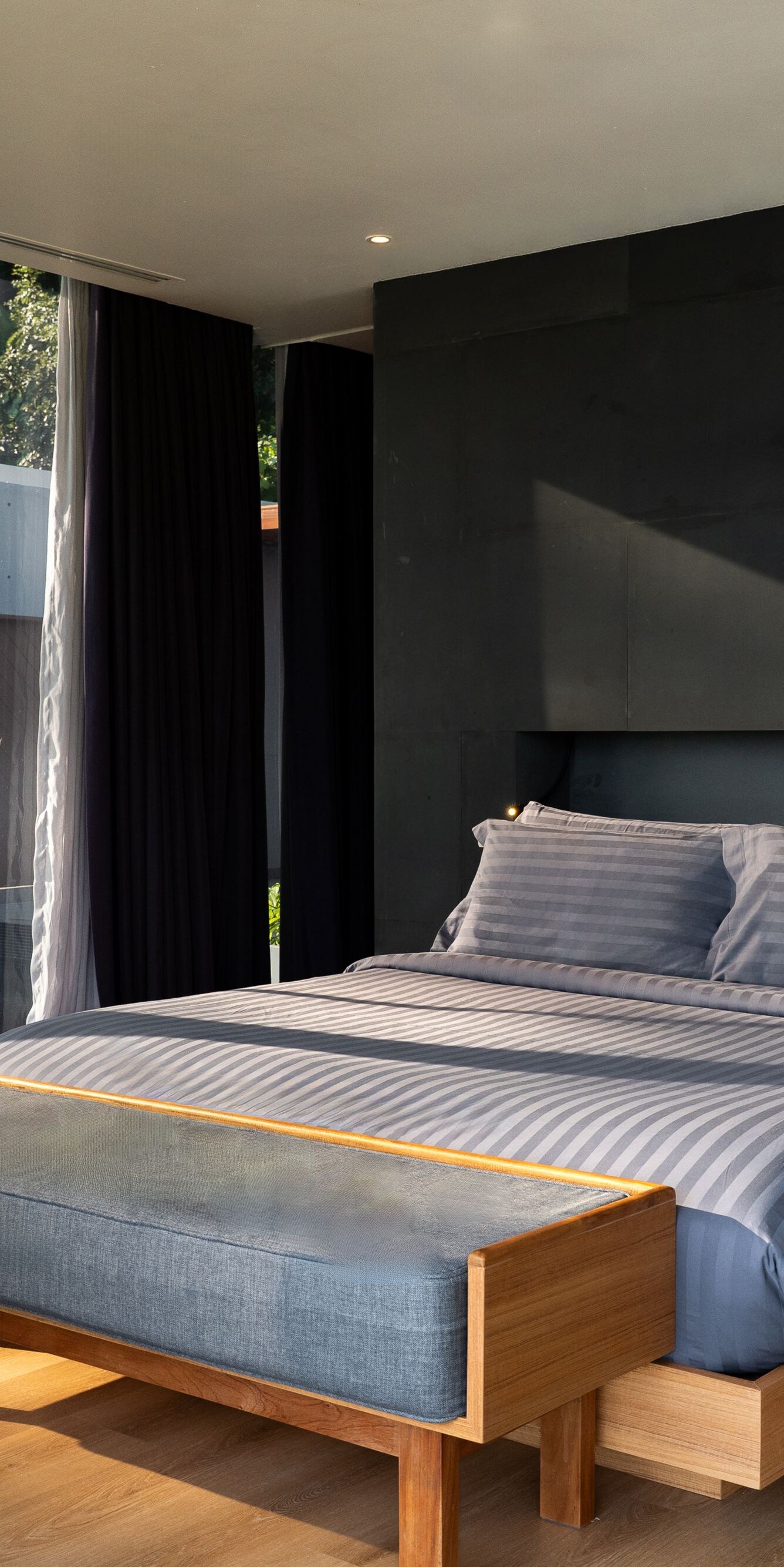 Modern bedroom with large window and gray bedding