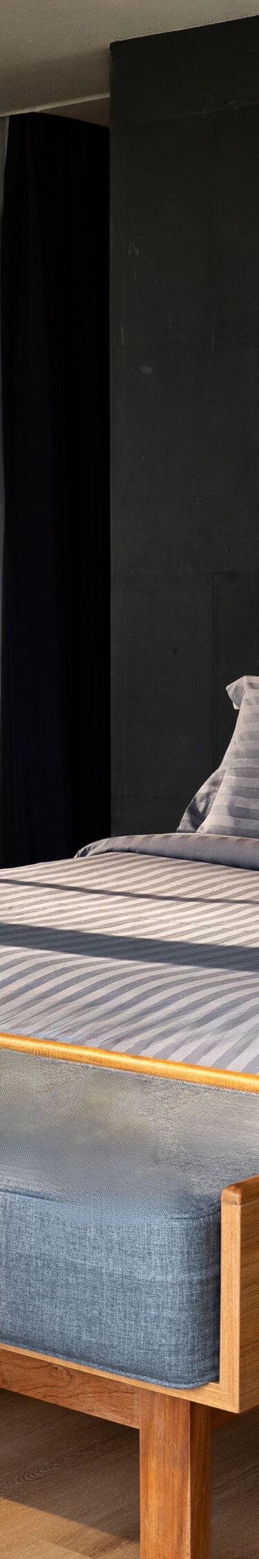Modern bedroom with large window and gray bedding