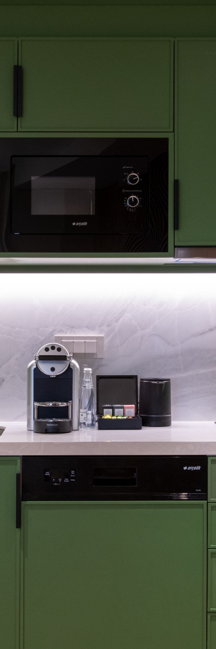 green cabinets, microwave, sink, dishwasher