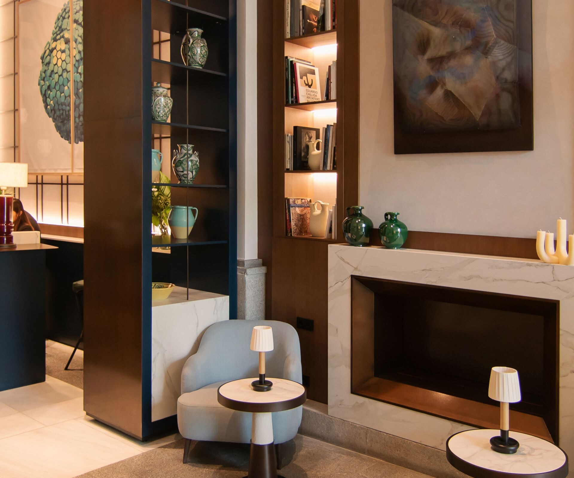 Lounge seating area with fireplace and bookshelves
