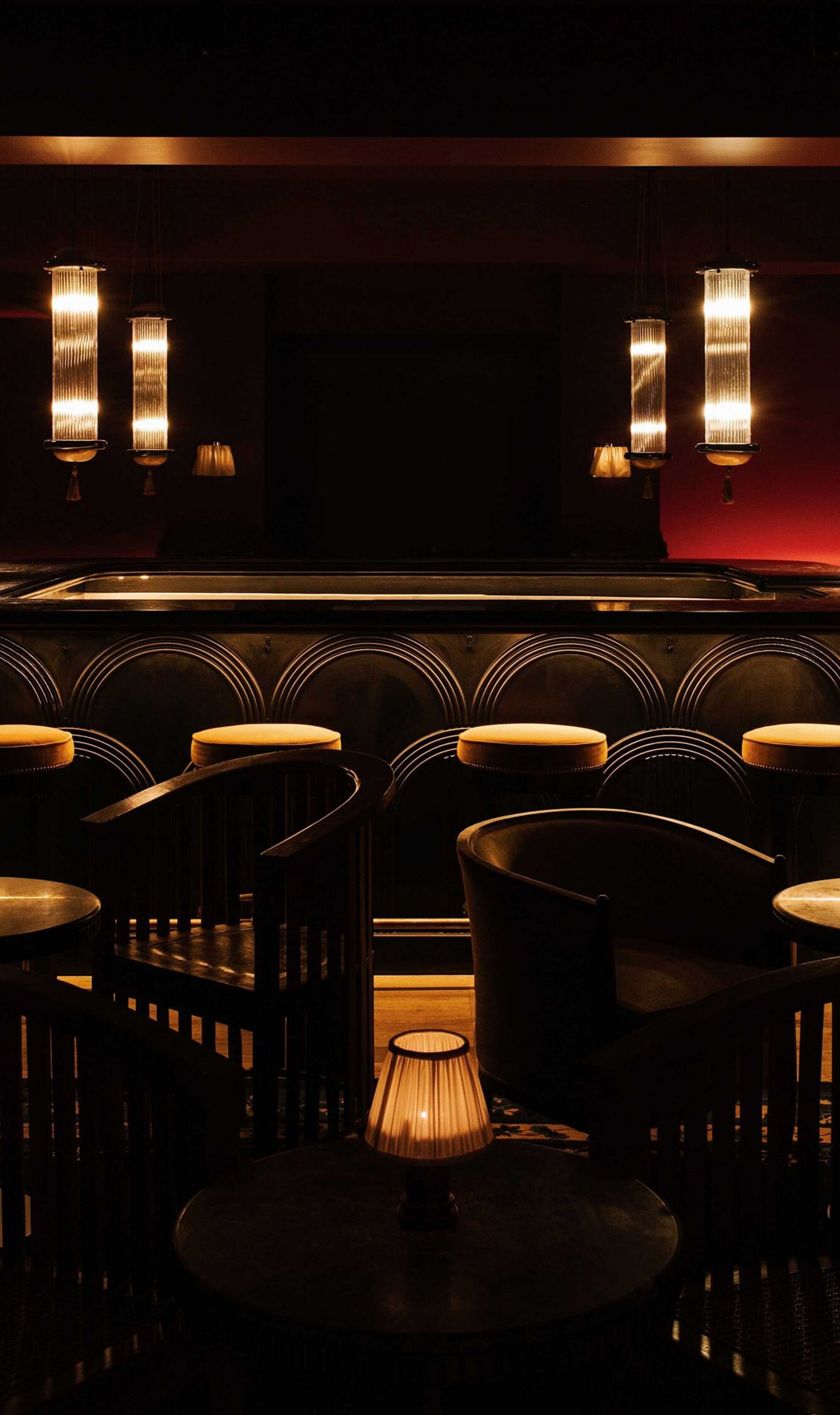 darkly lit bar with tables and chairs