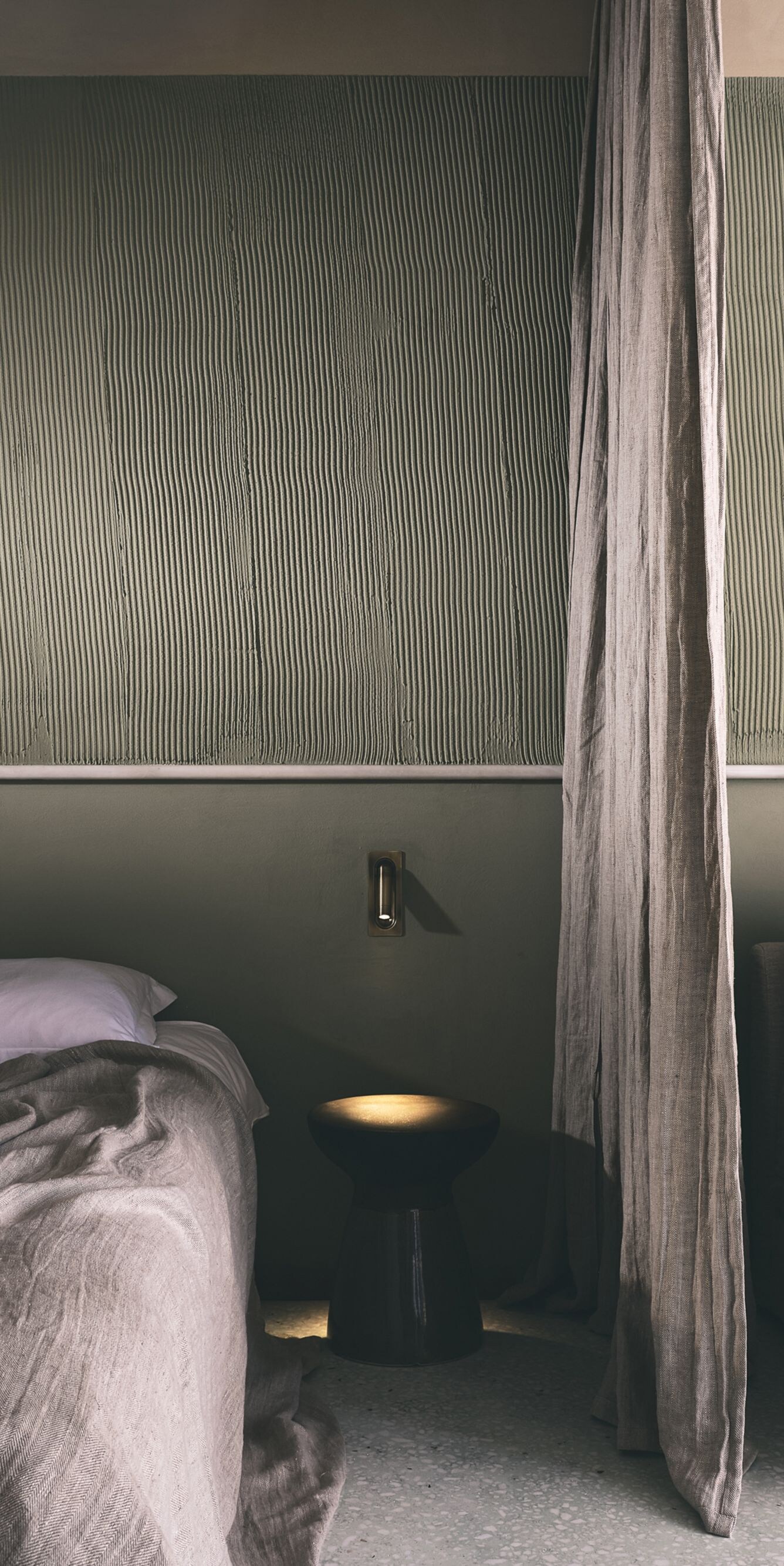 Bedroom and sofa separated by curtain