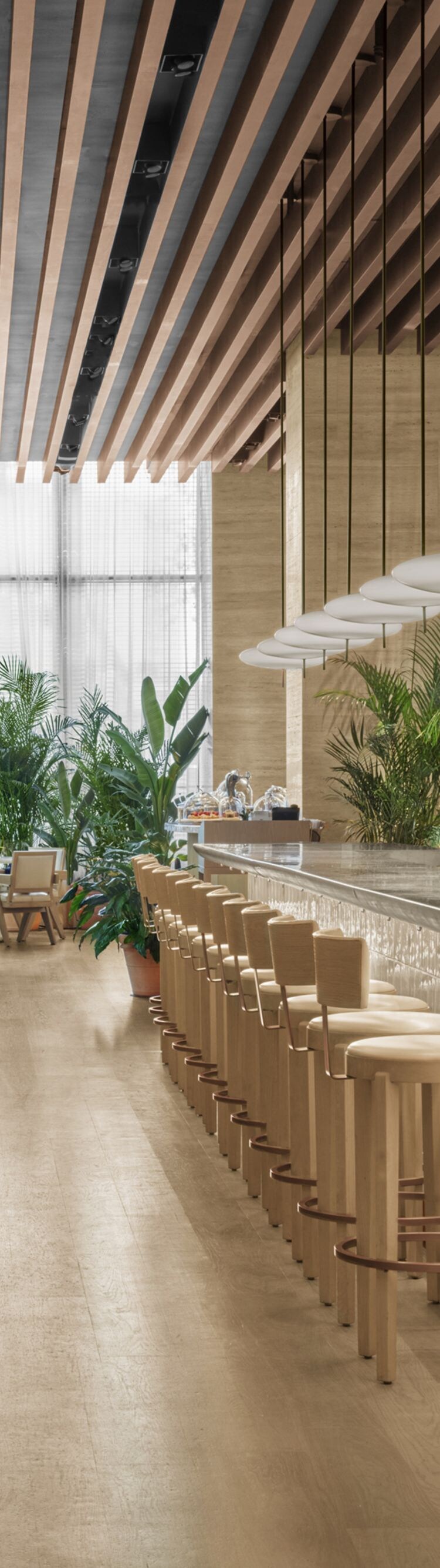 Bright restaurant with long bar and dining setup 