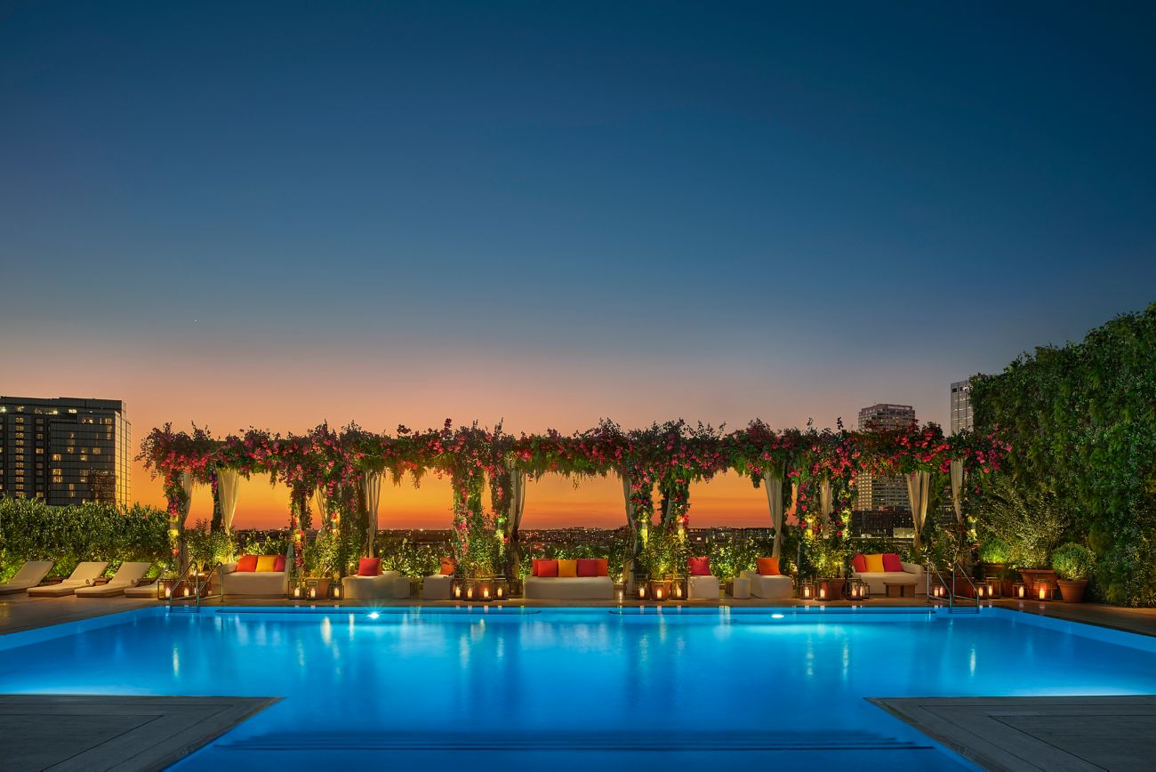 Rooftop pool and cabanas at sunset