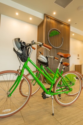 Two green bikes on hotel lobby