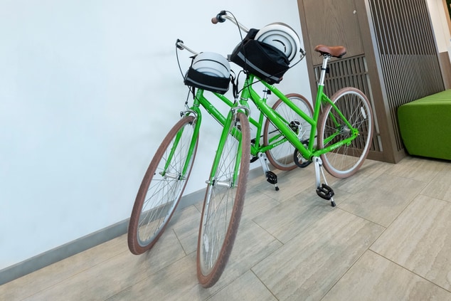 two green bikes on hotel lobby