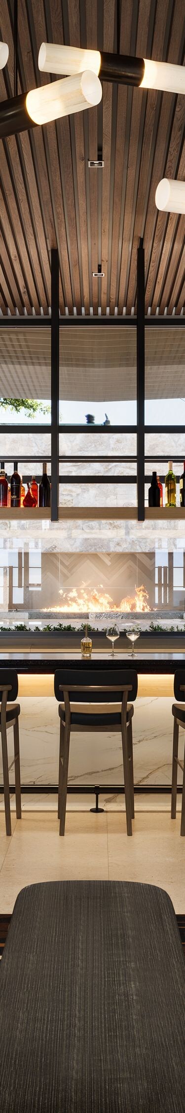 Modern bar with seating and fireplace