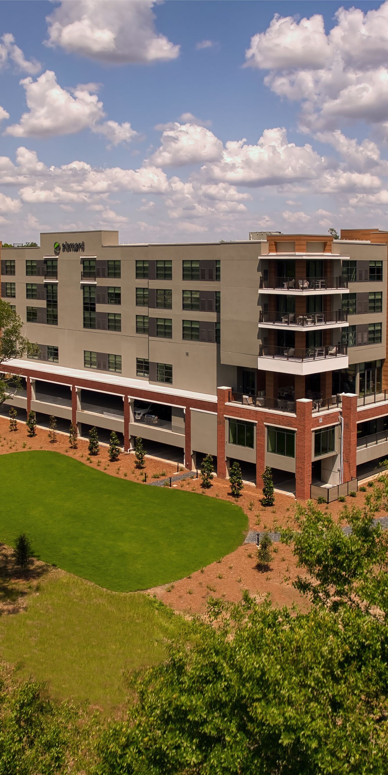 Hotel Exterior, pool area, greenspace, tress, sky