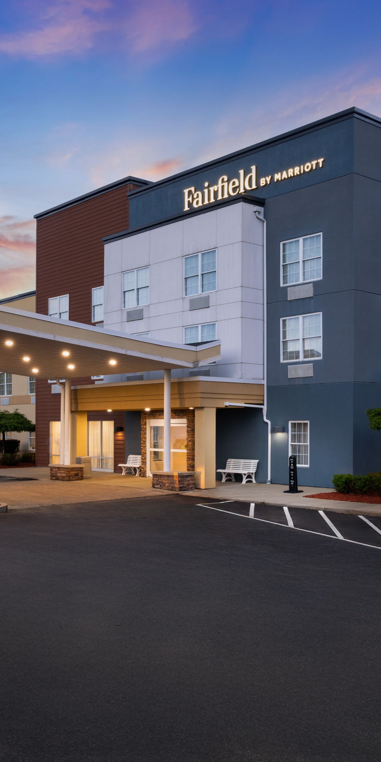 Hotel exterior and entrance at sunset.
