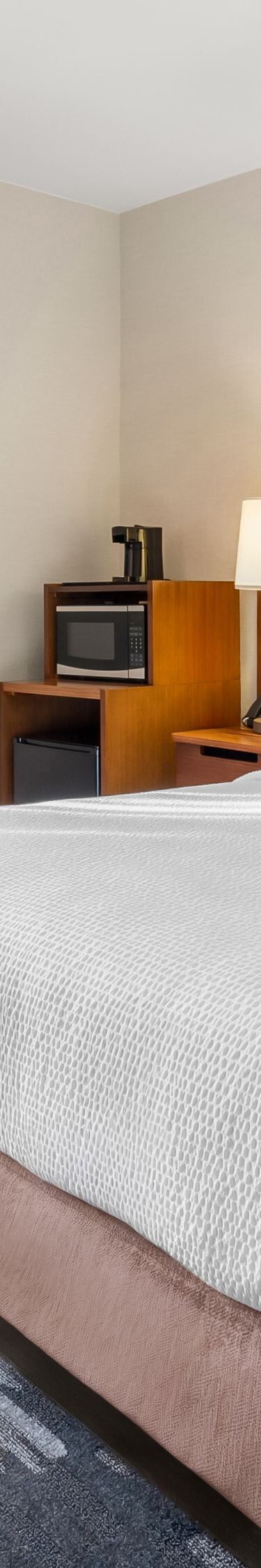 Queen bed, desk, window and seating area