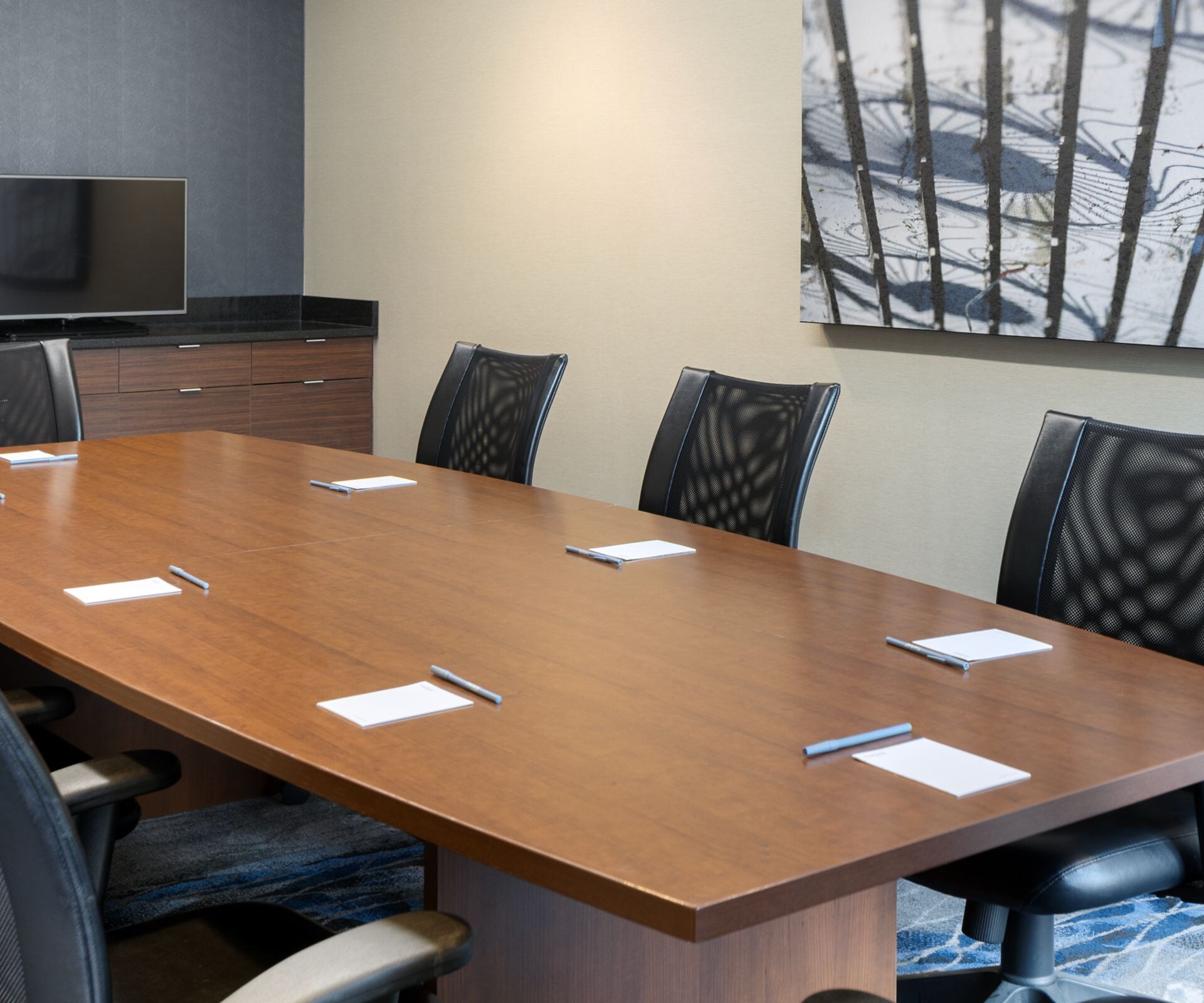 A collection of eight chairs around a large table.