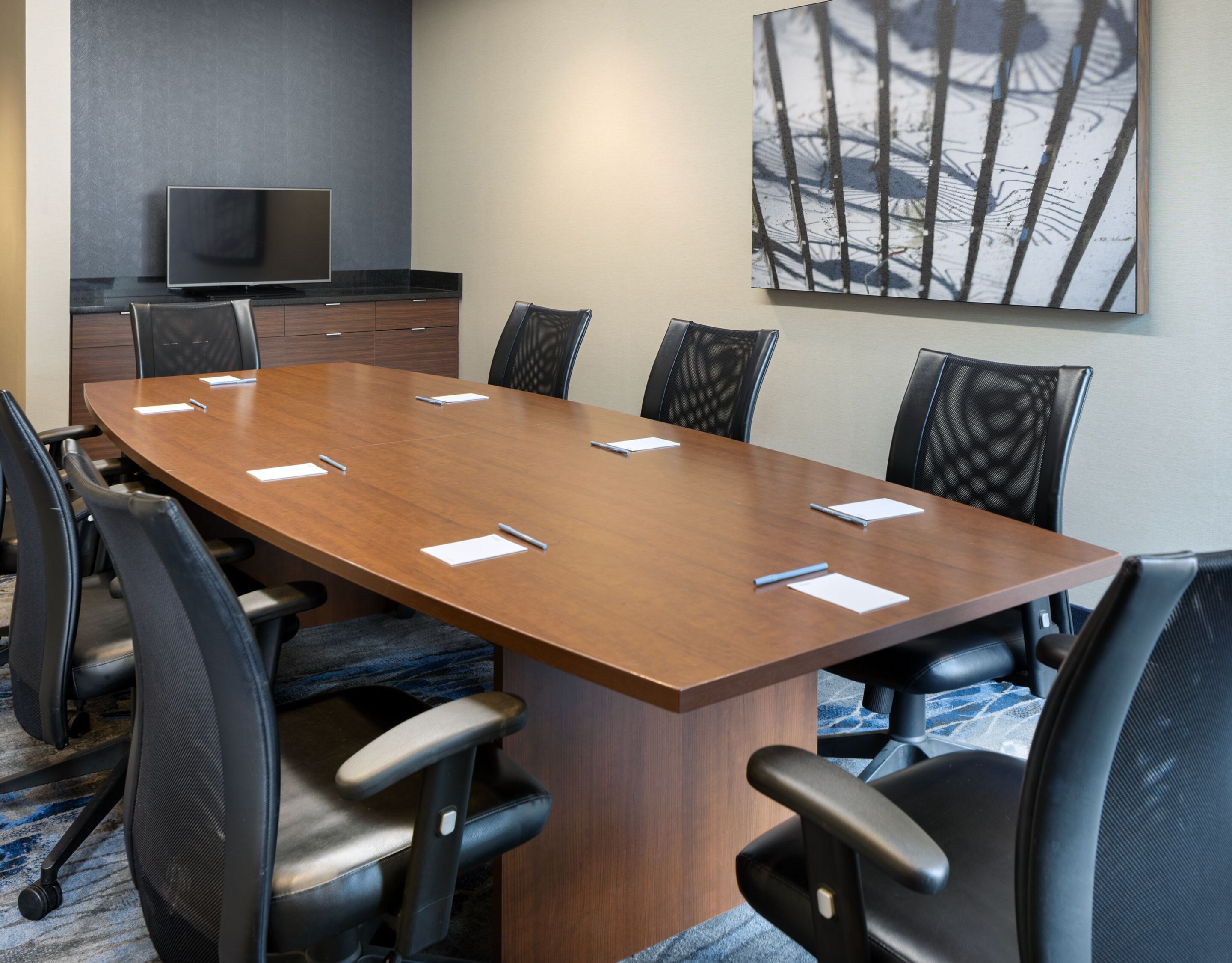 A collection of eight chairs around a large table.