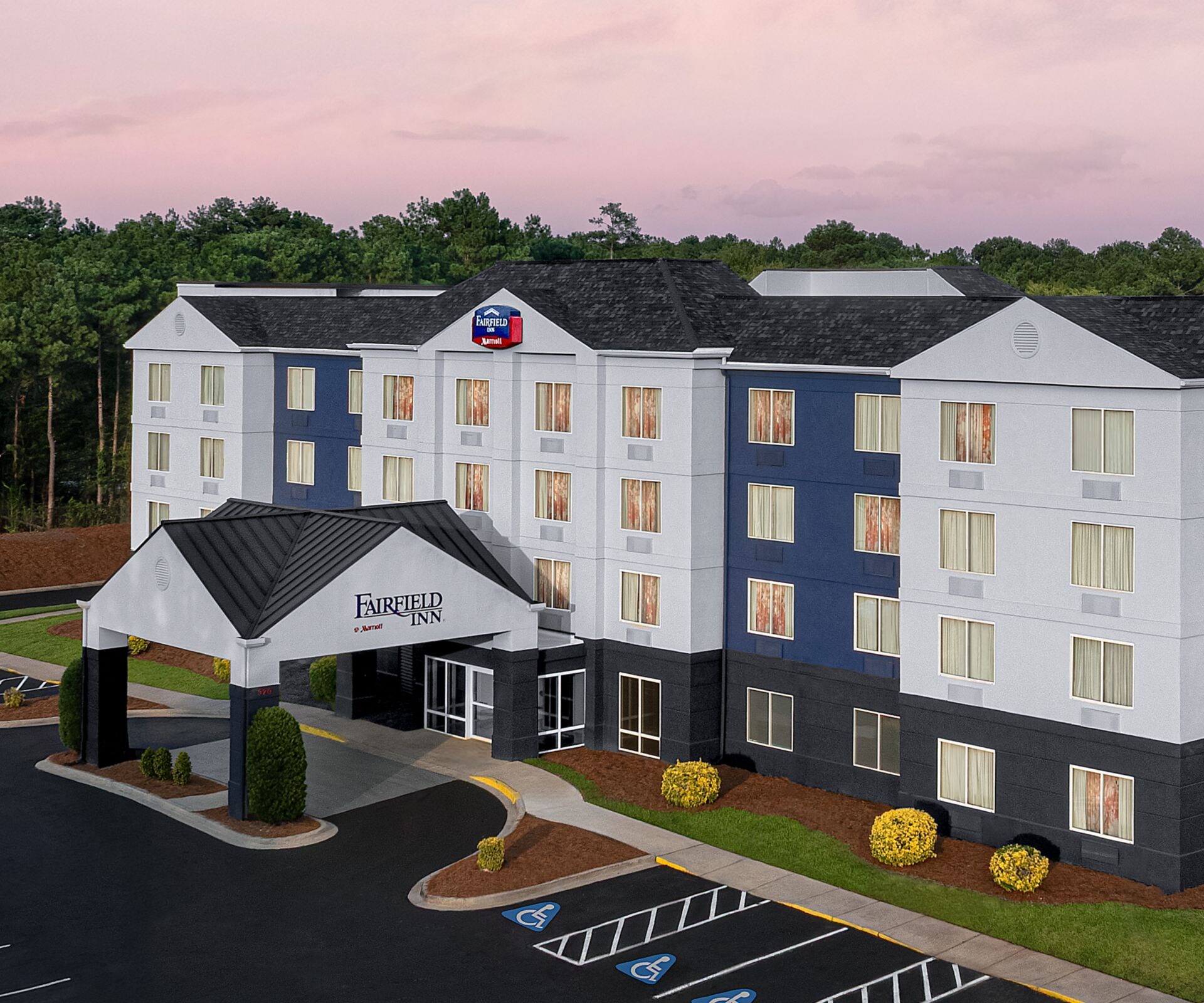 Exterior showcases parking and porte cochère.