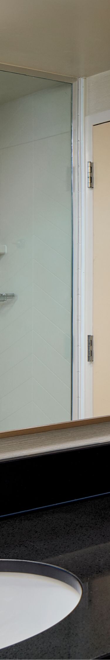 Bathroom vanity with mirror and glass shower door