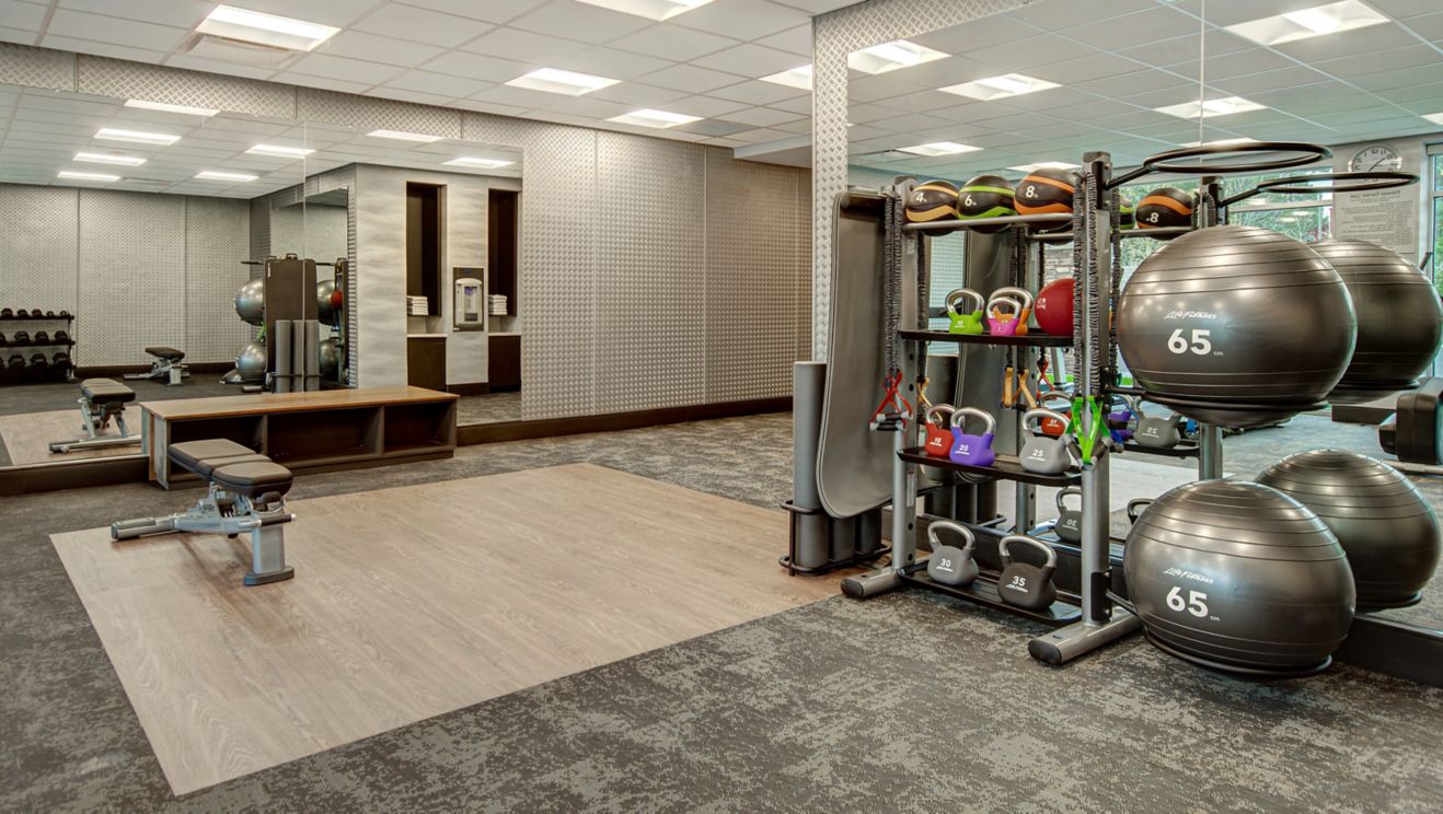 Fitness room includes free weights and more.
