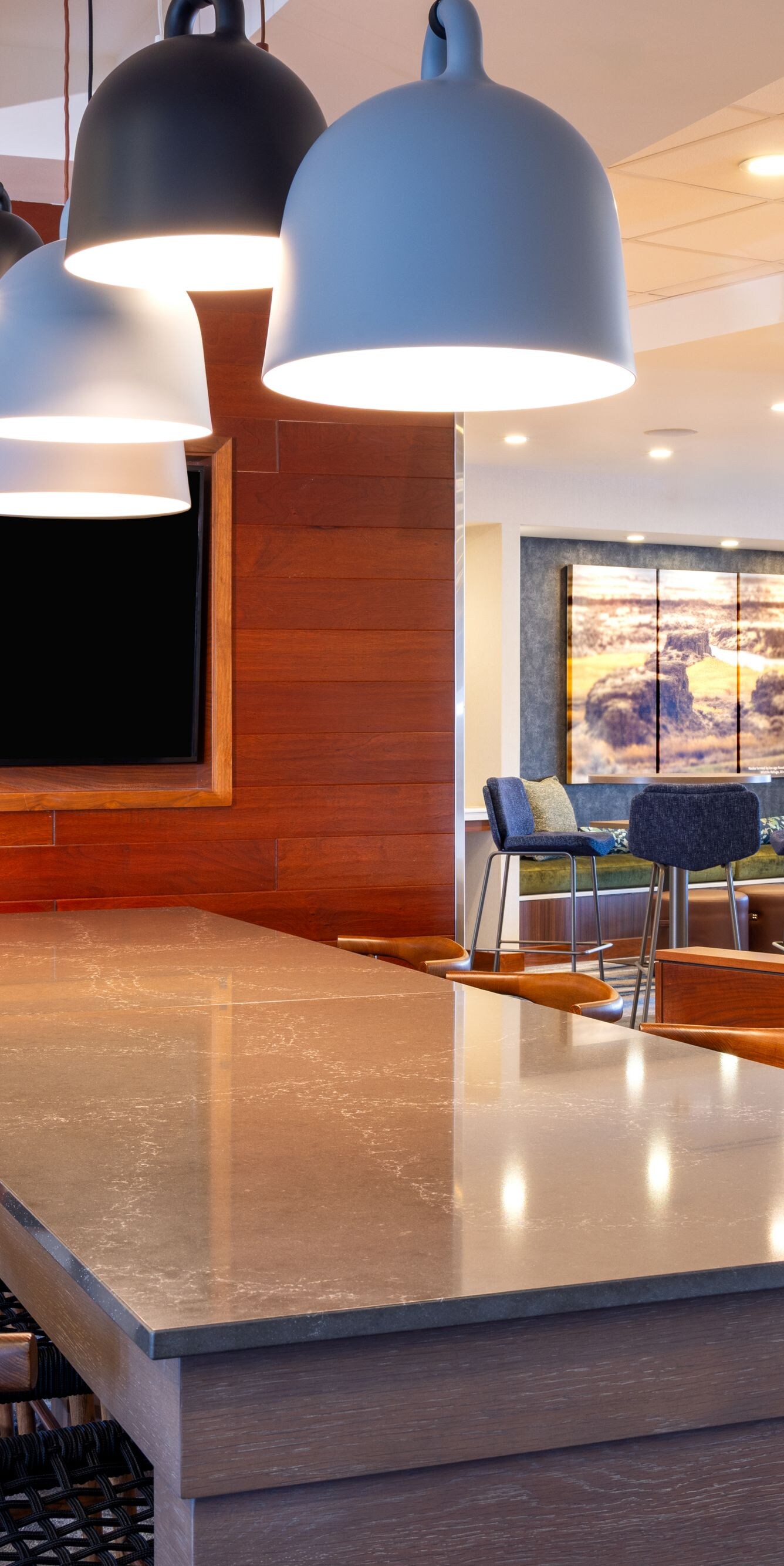 Long community table in lobby with television