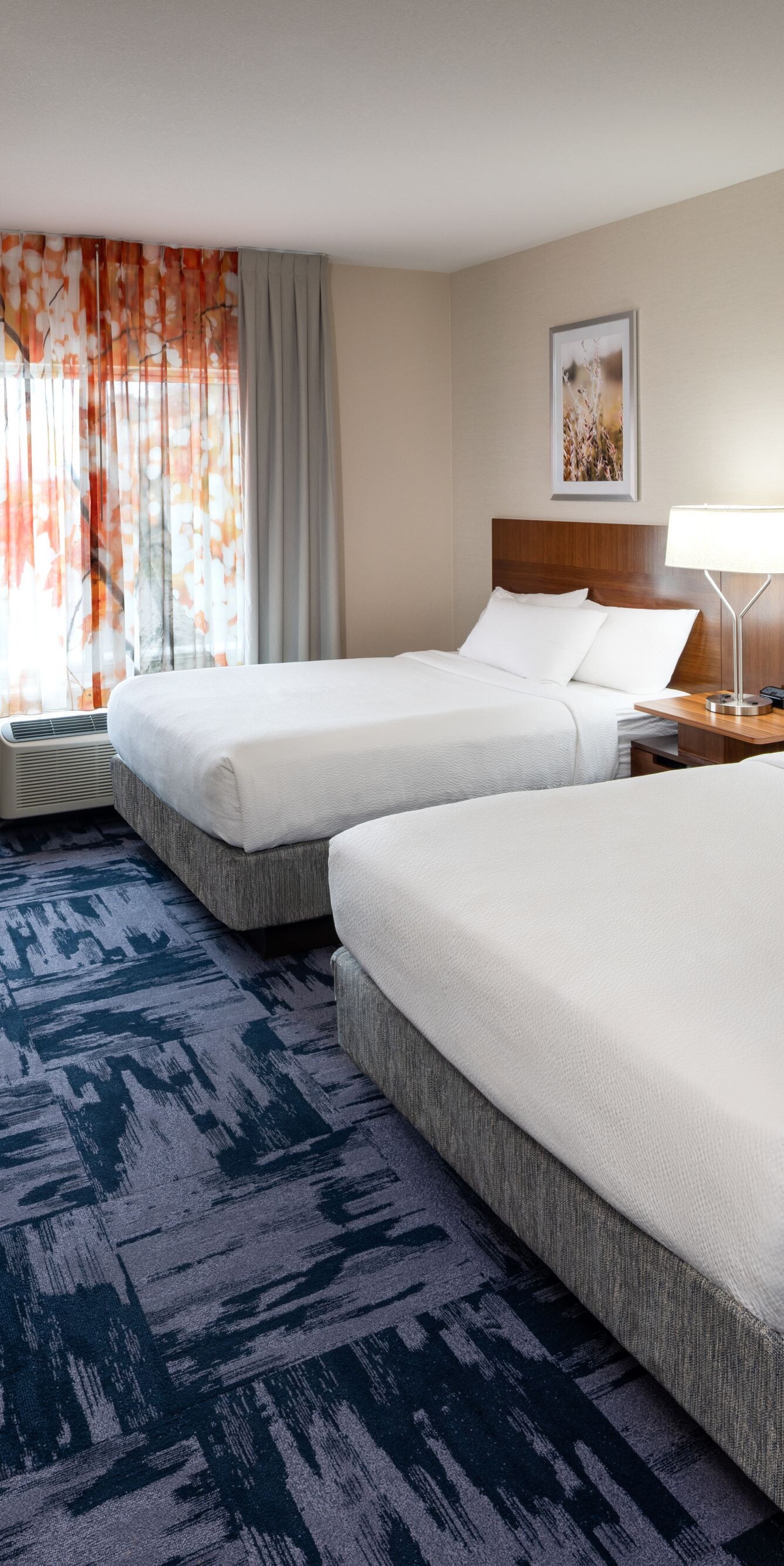 Guest room with two queen beds and seating area.