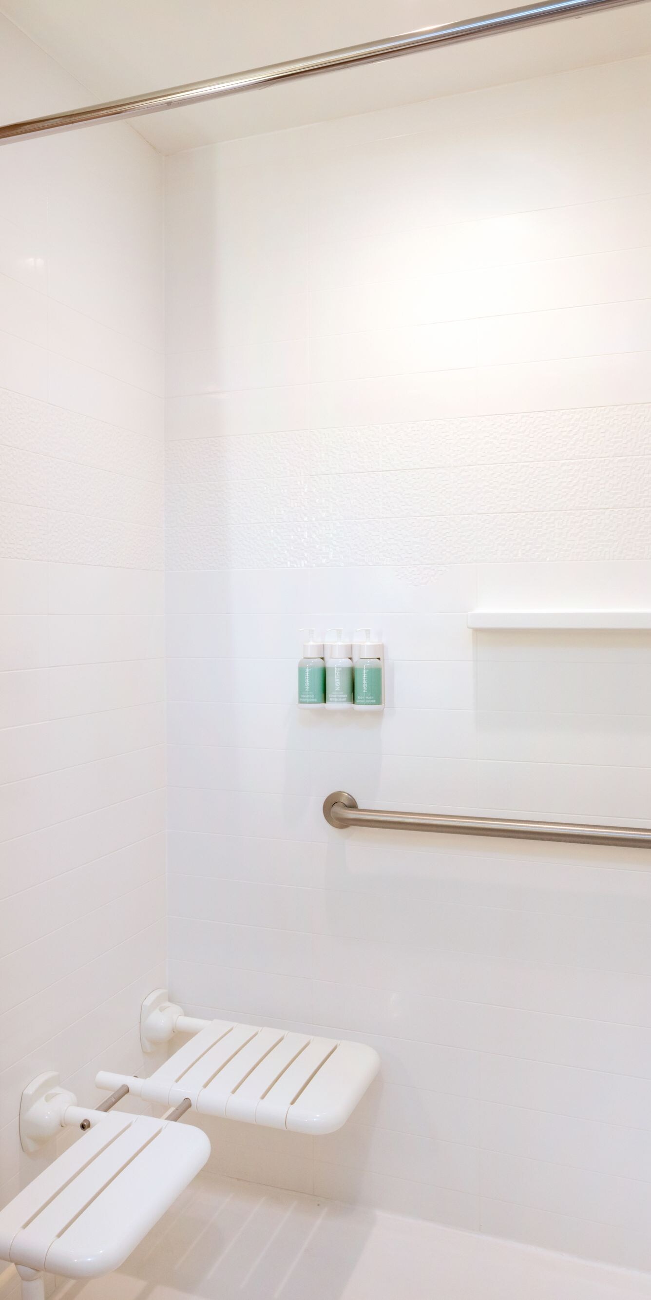 Accessible bathroom with roll-in shower, grab bar