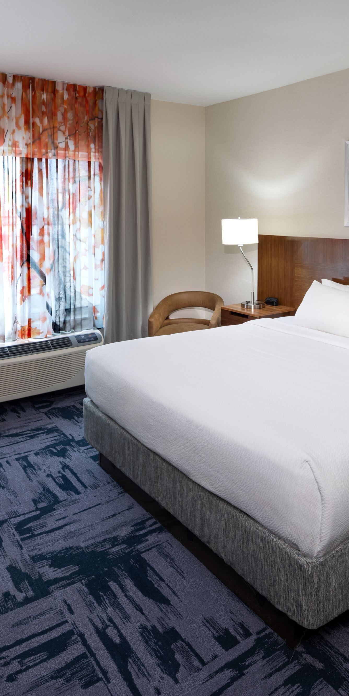 King guest room with plush bedding and seating are