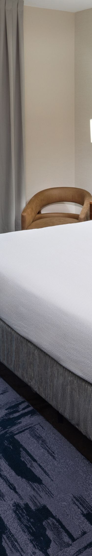 King guest room with plush bedding and seating are