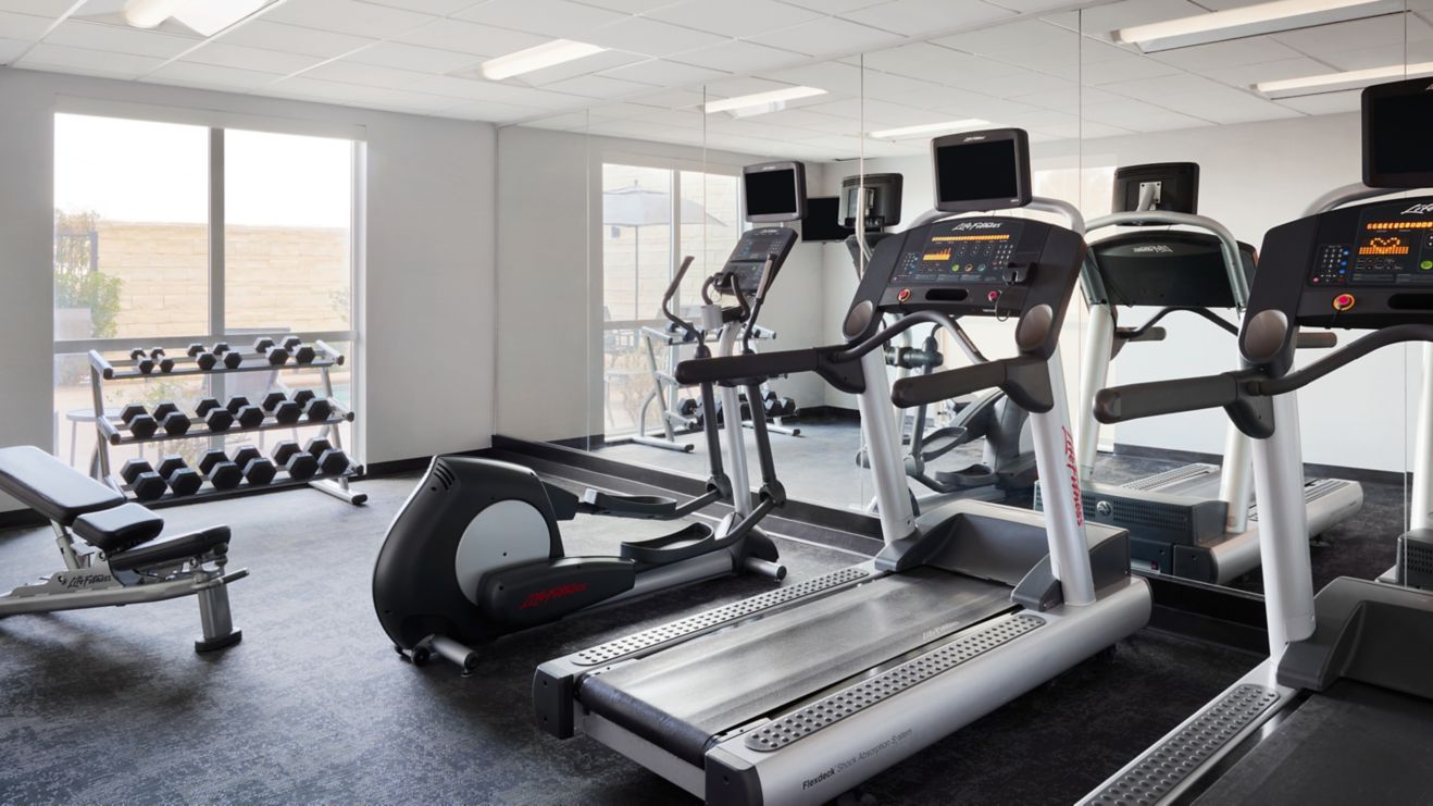 fitness center with weights and treadmills